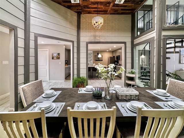 6803 Las Brisas Dr, Houston, TX 77083 - dining area featuring wood walls, an inviting chandelier, baseboards, and a high ceiling