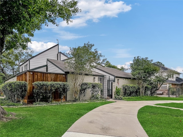 6803 Las Brisas Dr, Houston, TX 77083 - view of front of house featuring brick siding, fence, a gate, and a front lawn