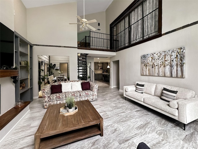 6803 Las Brisas Dr, Houston, TX 77083 - living area with stairs, ceiling fan, baseboards, and a towering ceiling