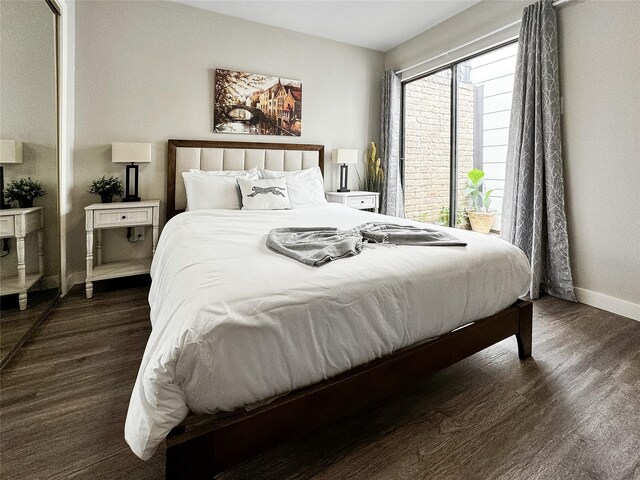 6803 Las Brisas Dr, Houston, TX 77083 - bedroom featuring baseboards and dark wood-type flooring