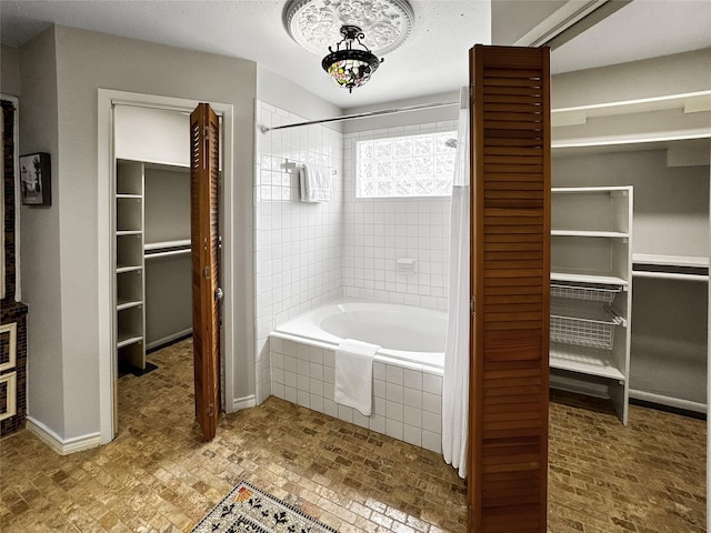 6803 Las Brisas Dr, Houston, TX 77083 - full bath featuring a walk in closet, tiled shower / bath, and baseboards