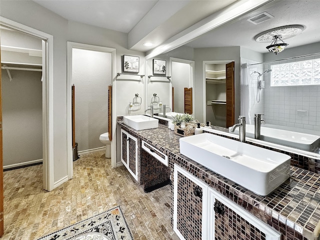 6803 Las Brisas Dr, Houston, TX 77083 - bathroom with double vanity, a walk in closet, visible vents, a sink, and toilet
