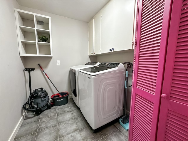 6803 Las Brisas Dr, Houston, TX 77083 - washroom with cabinet space, tile patterned floors, baseboards, and washer and clothes dryer