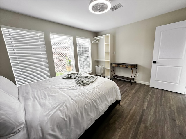 6803 Las Brisas Dr, Houston, TX 77083 - bedroom with visible vents, baseboards, and dark wood-style floors