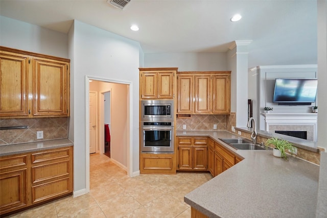 25702 Serene Spring Ln, Spring, TX 77373 - kitchen with stainless steel appliances, a sink, tasteful backsplash, light tile patterned floors, and a fireplace