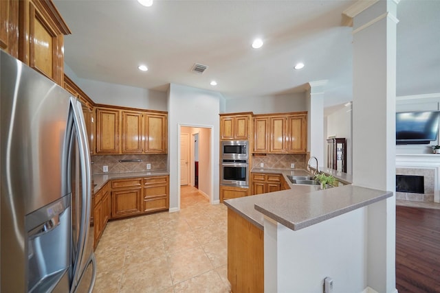 25702 Serene Spring Ln, Spring, TX 77373 - kitchen with stainless steel appliances, a sink, a peninsula, decorative backsplash, and recessed lighting