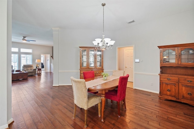 dining room with visible vents, baseboards, dark wood-type flooring, and ceiling fan with notable chandelier