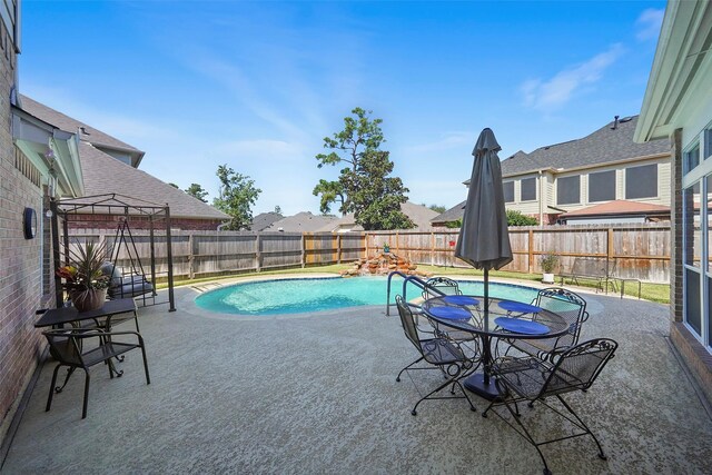 view of swimming pool featuring a patio, a fenced in pool, and a fenced backyard