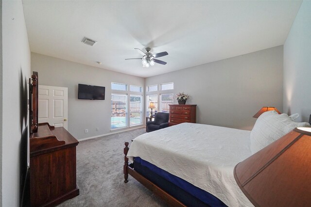 bedroom with baseboards, a ceiling fan, carpet flooring, and visible vents