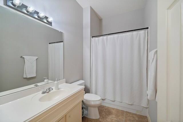 full bathroom with vanity, tile patterned flooring, toilet, and shower / tub combo with curtain