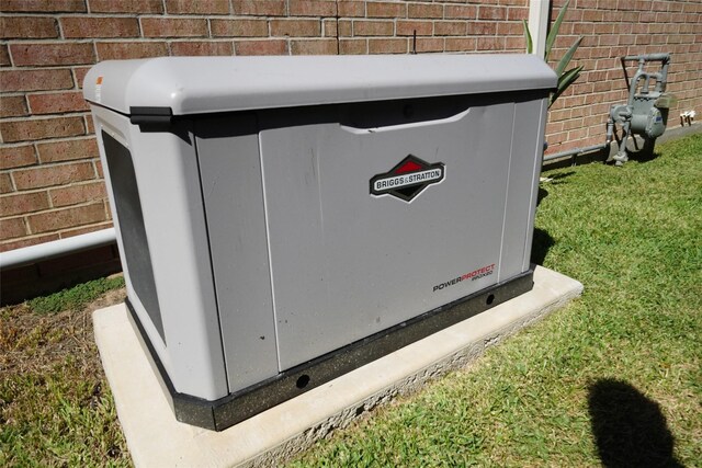 exterior details featuring brick siding, gas meter, and a power unit