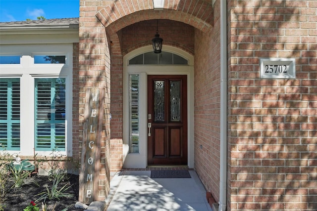 property entrance featuring brick siding
