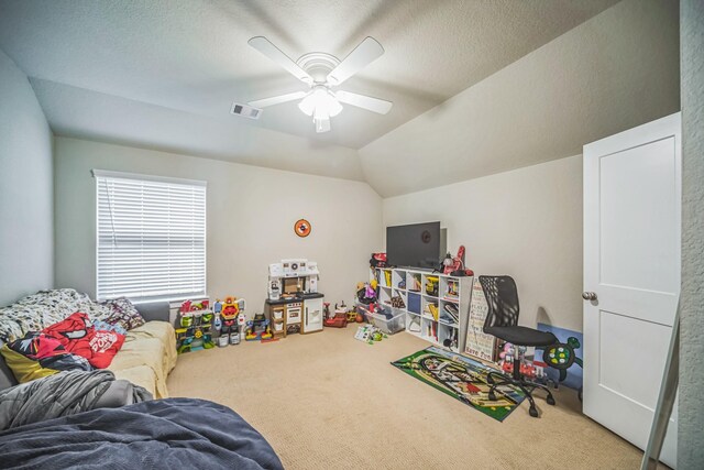 game room featuring ceiling fan, visible vents, lofted ceiling, and carpet