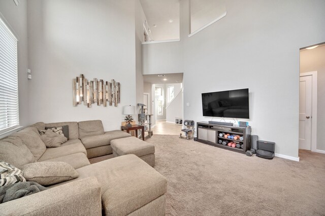 living room with baseboards, carpet, and a towering ceiling