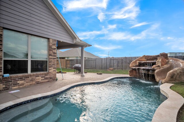 view of swimming pool with grilling area, a fenced in pool, fence private yard, and a patio area