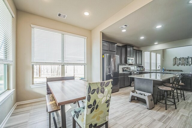 kitchen featuring light countertops, baseboards, stainless steel appliances, and visible vents