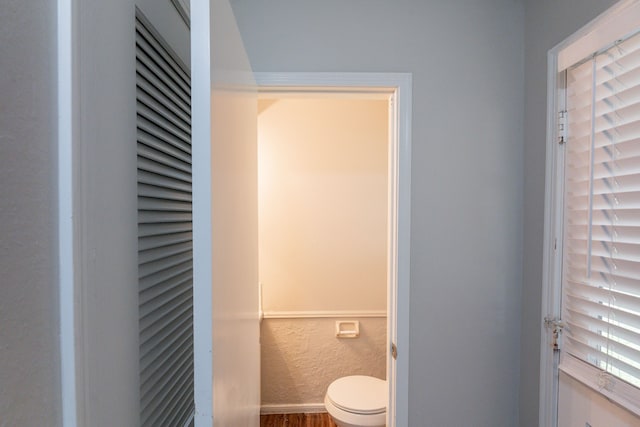 bathroom featuring toilet and wood finished floors