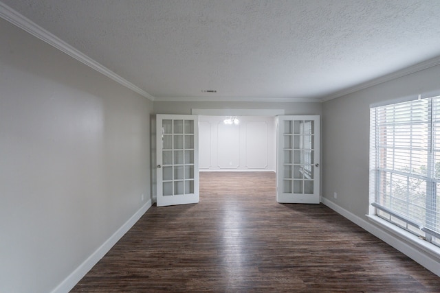 spare room featuring baseboards, a textured ceiling, and dark wood finished floors