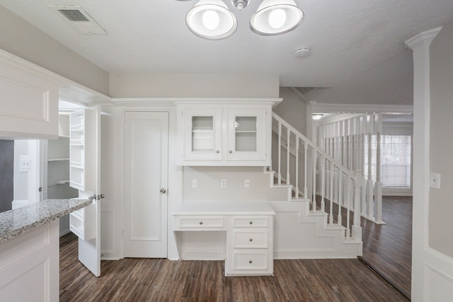 stairs with visible vents and wood finished floors