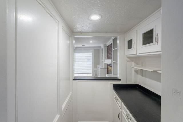 interior space with recessed lighting, a textured ceiling, and a decorative wall