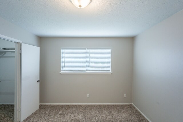 15807 Ripplewind Ln, Houston, TX 77068 - unfurnished bedroom featuring carpet flooring, a closet, a textured ceiling, and baseboards