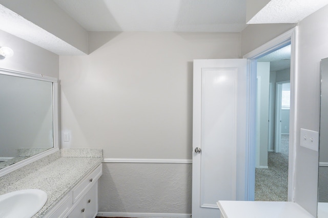 bathroom with baseboards and vanity