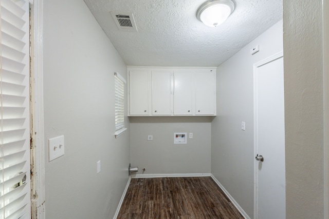 laundry area with visible vents, dark wood-type flooring, a textured ceiling, cabinet space, and washer hookup
