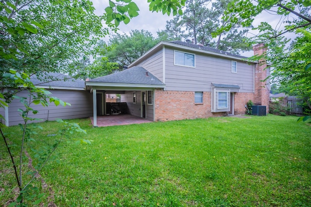 back of property featuring a yard, brick siding, fence, and a patio area
