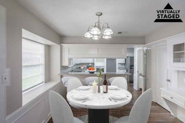 15807 Ripplewind Ln, Houston, TX 77068 - dining area featuring a chandelier and dark wood finished floors