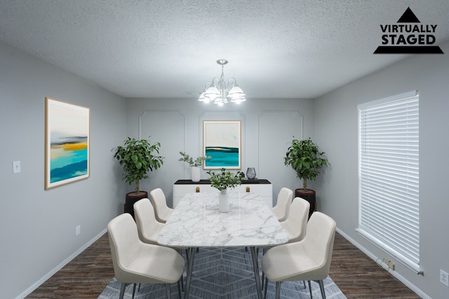 15807 Ripplewind Ln, Houston, TX 77068 - dining space with a textured ceiling, a chandelier, dark wood-type flooring, baseboards, and healthy amount of natural light