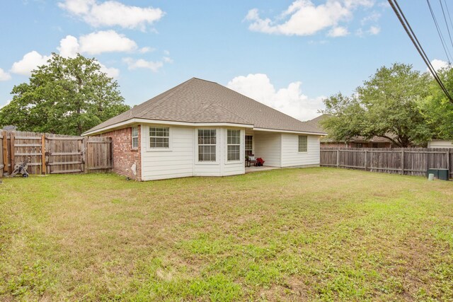 3107 Pleasant Forest Dr, College Station, TX 77845 - rear view of property featuring a lawn, a fenced backyard, and a patio area