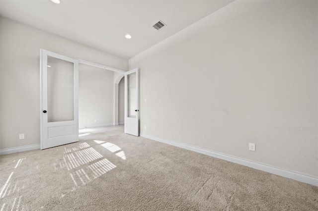 11018 Croftmore Dr, Richmond, TX 77407 - unfurnished bedroom with visible vents, arched walkways, baseboards, light carpet, and recessed lighting