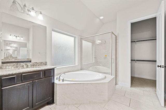 11018 Croftmore Dr, Richmond, TX 77407 - full bathroom featuring a garden tub, vanity, a spacious closet, a shower stall, and vaulted ceiling