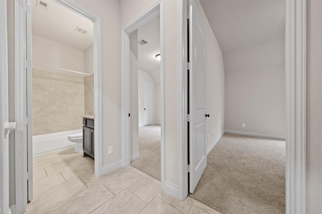 11018 Croftmore Dr, Richmond, TX 77407 - hall featuring light colored carpet, baseboards, visible vents, and light tile patterned flooring