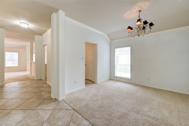 empty room with an inviting chandelier, ornamental molding, lofted ceiling, and light carpet