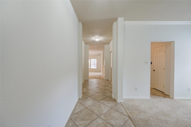 corridor featuring light tile patterned floors and baseboards