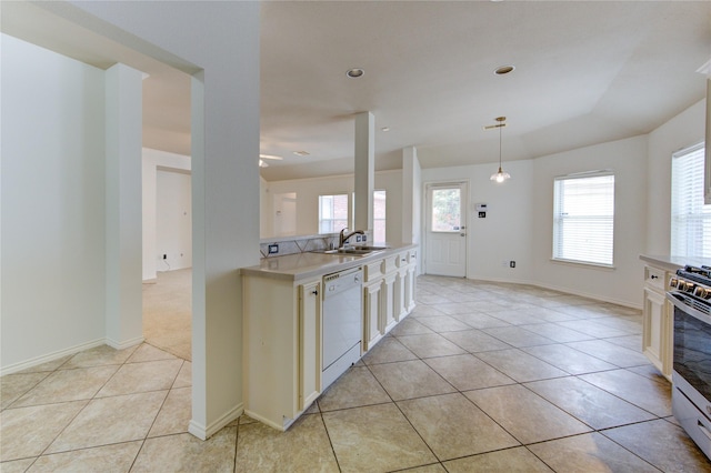 kitchen featuring dishwasher, a sink, gas stove, light countertops, and light tile patterned flooring