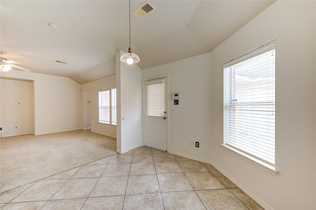 entryway featuring visible vents, a ceiling fan, baseboards, and vaulted ceiling