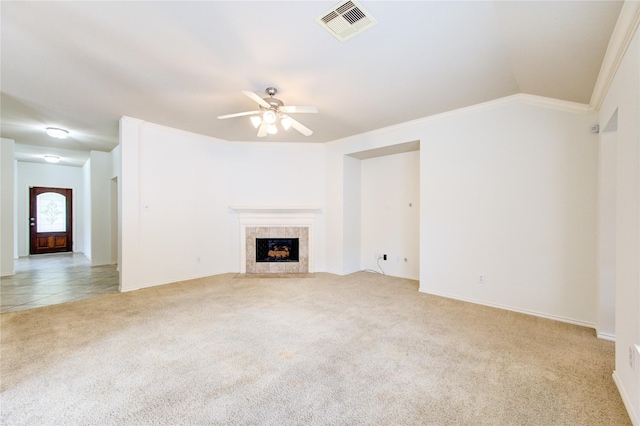 unfurnished living room featuring ceiling fan, light colored carpet, crown molding, visible vents, and a fireplace