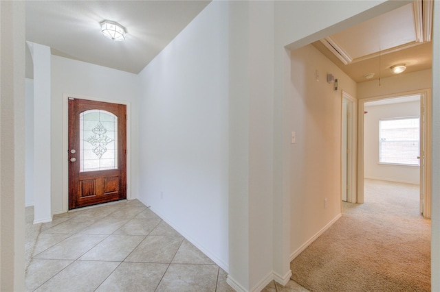 foyer with light tile patterned floors and baseboards