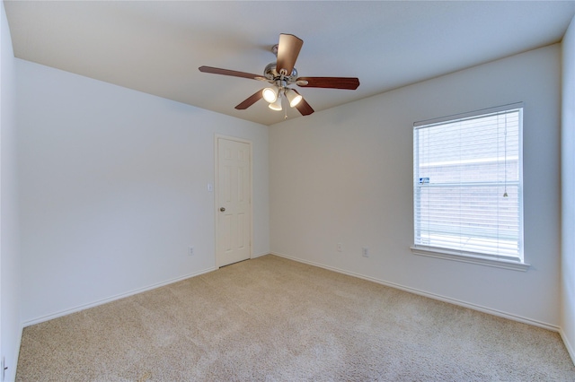 unfurnished room with light colored carpet and baseboards