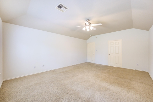 unfurnished room with ceiling fan, visible vents, light carpet, and lofted ceiling