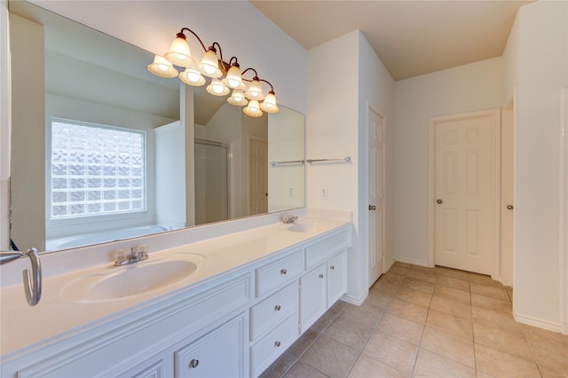 bathroom featuring a sink, baseboards, a stall shower, and double vanity