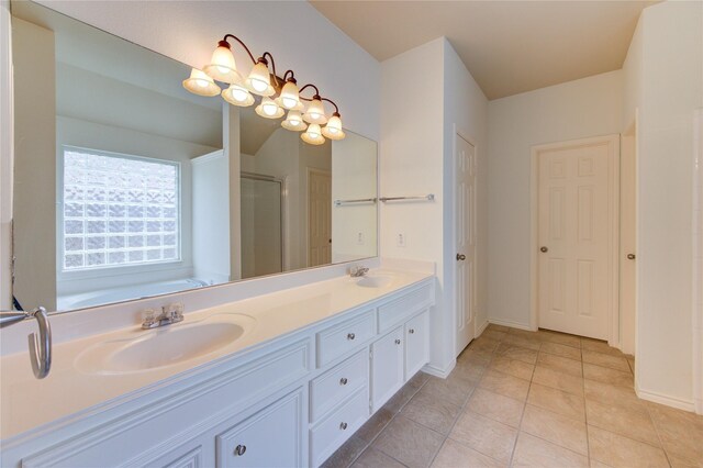 26707 Abbey Springs Ln, Katy, TX 77494 - bathroom featuring a sink, baseboards, a stall shower, and double vanity