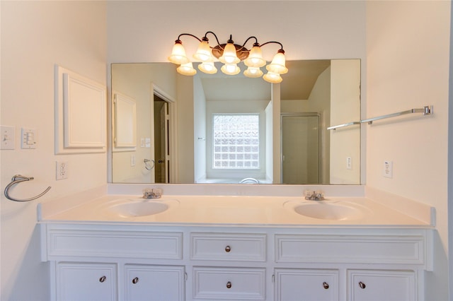 full bath featuring double vanity, a sink, and a stall shower