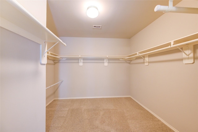 walk in closet featuring carpet flooring and visible vents