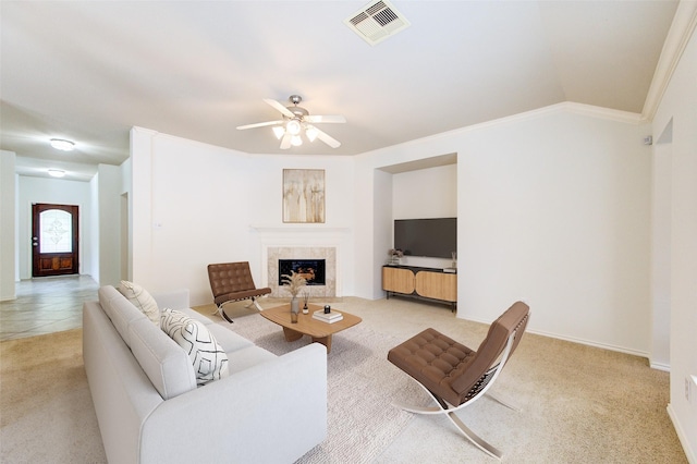 26707 Abbey Springs Ln, Katy, TX 77494 - living room with ceiling fan, visible vents, a tiled fireplace, ornamental molding, and light carpet