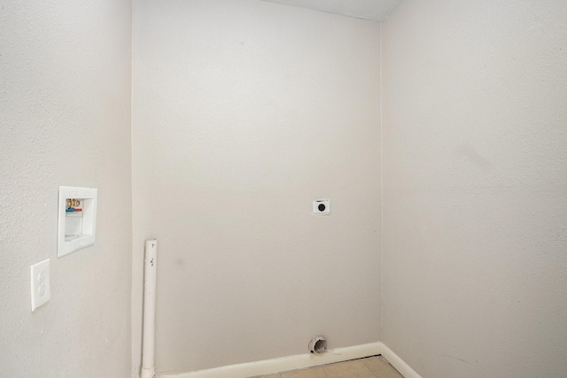 laundry area with electric dryer hookup, hookup for a washing machine, and light tile patterned flooring