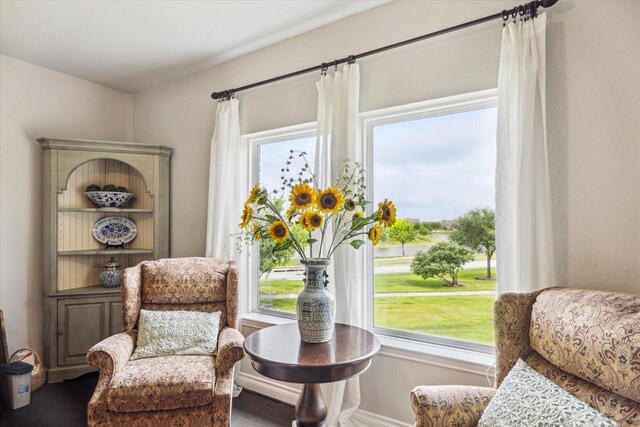 sitting room featuring baseboards and wood finished floors