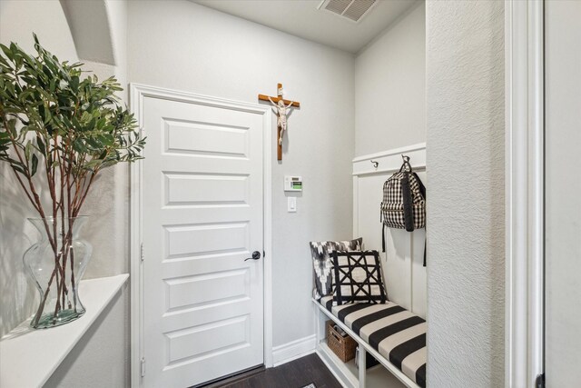 mudroom with dark wood finished floors and visible vents